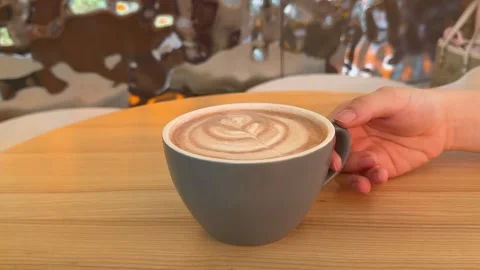 Gray Cup of Fresh Coffee with Beautiful Latte Art on Rustic Wooden Table Stock Footage 345172038