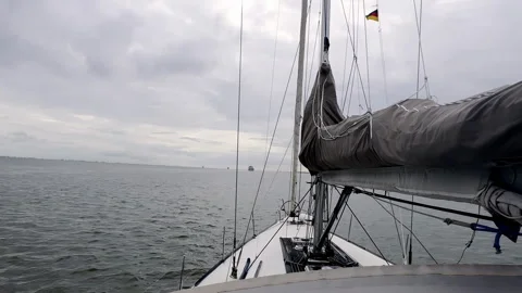 Gray Day on the North Sea Facing the Elements Head-On as a Sailboat Charts a Stock Footage 297740034