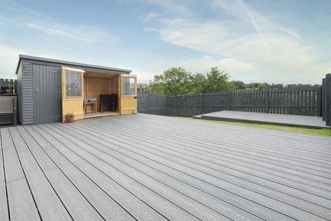 Gray deck stretches wide under clear blue sky Stock Photos
