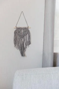 Gray decoration with macrame for the interior in the house. Handmade Fotos de archivo