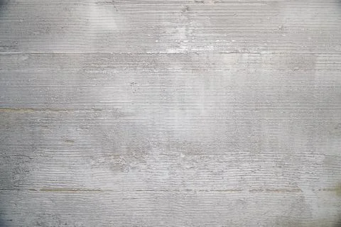 Gray decorative plaster on the wall with pressed horizontal stripes Stock Photos