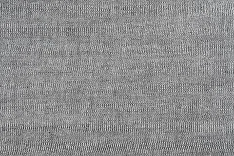 Gray denim fabric texture closeup with diagonal weave pattern Stock Photos