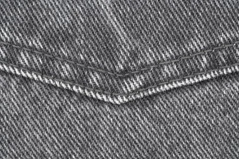 Gray denim fabric texture with diagonal stitching pattern top view Stock Photos