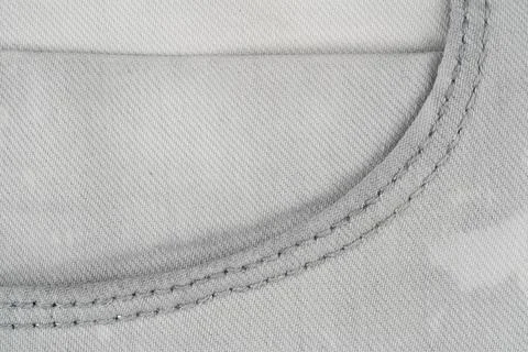 Gray denim fabric texture with visible stitching detail top view Stock Photos