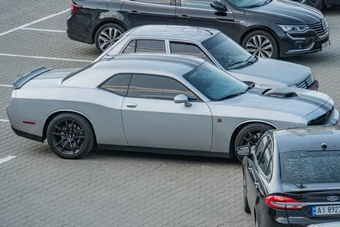 Gray Dodge Charger SRT Hellcat parked in a parking lot, adjacent to other v.. Stock Photos
