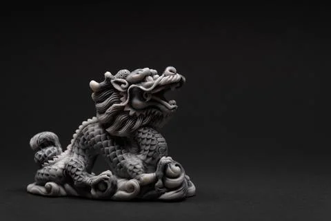 Gray dragon statue on a black background. The symbol of 2024. Stock Photos