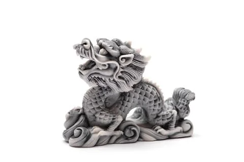 Gray dragon statue on a white background. The symbol of 2024. Stock Photos