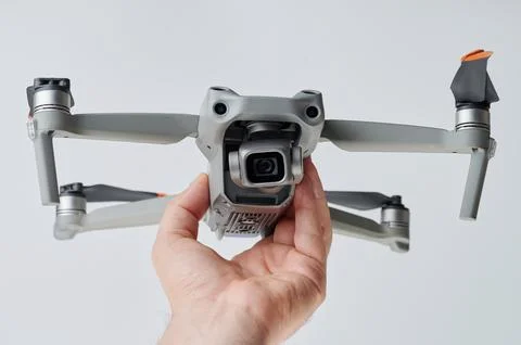 Gray drone with camera in hand Stock Photos
