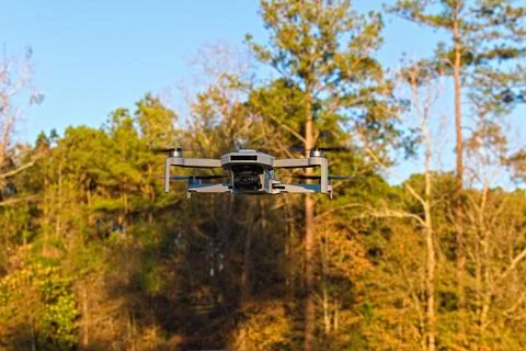 A Gray Drone Hovers in Flight Stock Photos