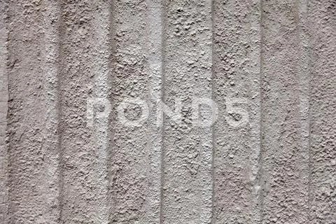 Gray dull background with a rough stone texture with vertical stripes of beig Stock Photos