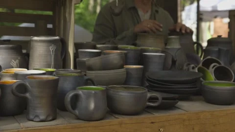 Gray earthenware at the craft market, cups, plates, bowls, vases Stock Footage 251846196