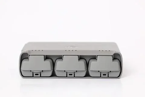 Gray electrical outlet with three sockets on white background Stock Photos