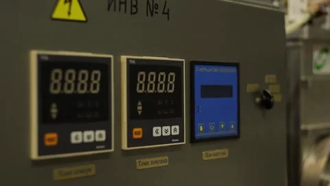 Gray electrical panel with digital displays, switch and buttons at the factory Stock Footage 226628195