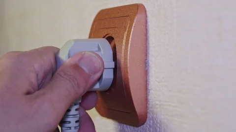 Gray electrical plug is inserted into the socket Stock Footage 103123343