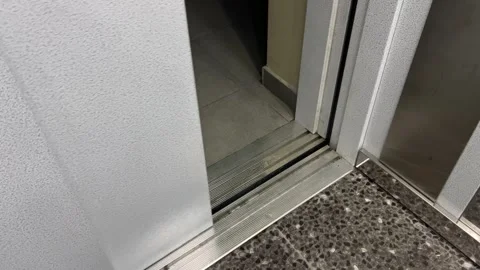 Gray elevator doors opening in entrance of multi-apartment residential building Stock Footage 340427578