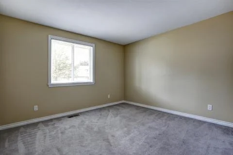 Gray Empty room interior with one window and carpet floor. House interior Stock Photos