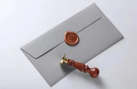 Gray envelope sealed with wax and wooden stamp Stock Photos