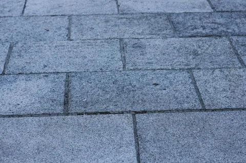 Gray evening pavement with rectangle cobblestones Stock Photos