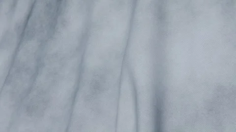 Gray fabric flows smoothly, illuminated by natural light and shadows Stock Footage 347877776