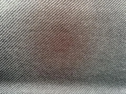 Gray fabric texture with a brown stain. Stock-Fotos