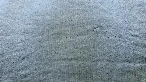 Gray fabric texture with central subtle stain abstract closeup background Stock Photos