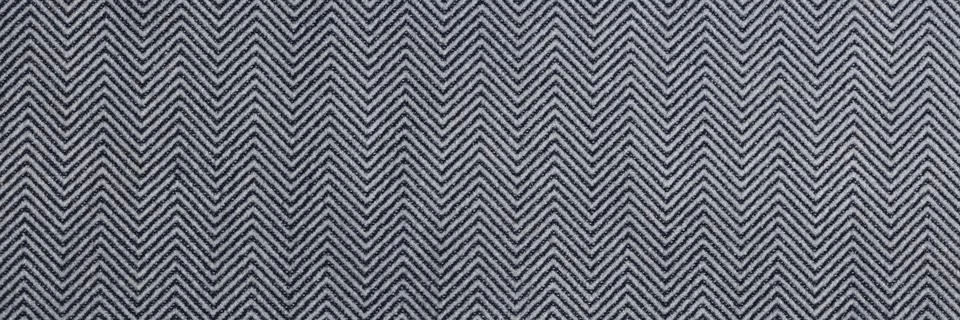 Gray fabric with zigzag pattern as background. Stock Photos