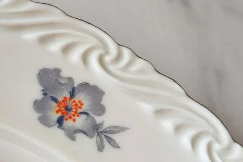 Gray flower pattern on antique porcelain plate closeup Stock Photos