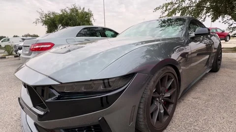 Gray Ford Mustang front quarter parked in outdoor lot with sporty design details Stock-Footage 333423931