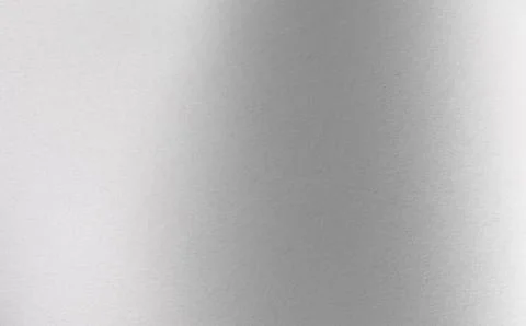 Gray gradient texture covers horizontal frame. Metallic surface displays ligh Foto stock