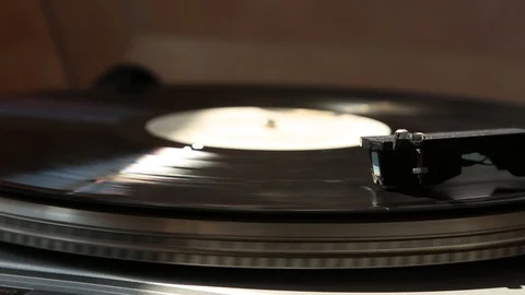 Gray gramophone. black Record is spinning. in the rays of light. Stock Footage 109189604