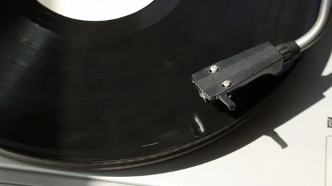 Gray gramophone. black Record is spinning. in the rays of light. Stock Footage 109189618