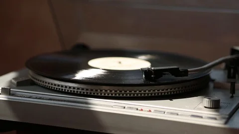 Gray gramophone. black Record is spinning. in the rays of light. Stock Footage 109189656