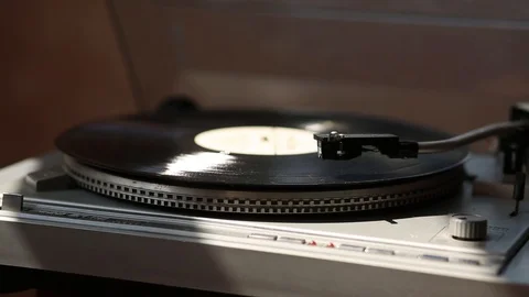 Gray gramophone. black Record is spinning. in the rays of light. Stock Footage 109189677