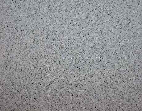 Gray granite with black splashes of fine fraction, polished surface of natura Stock Photos