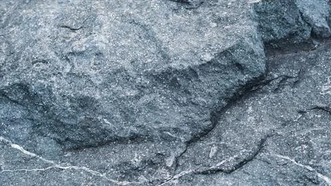 Gray granite surface with speckled texture, solid geological rock background. Stock Photos