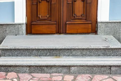 Gray granite threshold with steps covered with non-slip rubber strips. Stock Photos