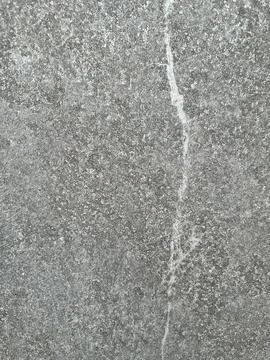 Gray granular textured surface Stock Photos