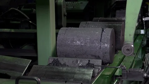 Gray graphite blanks are laid on the conveyor in a row, the tape moves forward Stock Footage 115926803