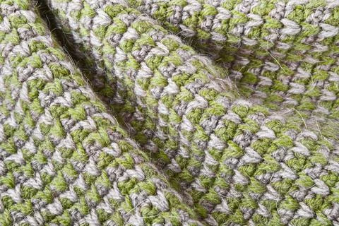 Gray green knitting wool texture background. Canvas is crocheted of natural Stock Photos