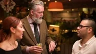 A Gray-Haired Adult Respectable Man Tells Something To Friends Near The Bar Stock Footage