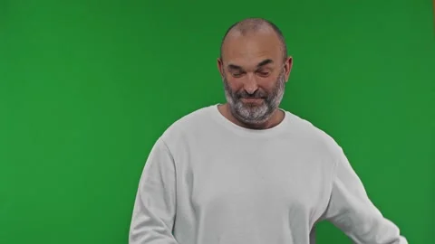 Gray-haired bearded man point fingers aside on workspace copy space isolated on Stock Footage 169282843