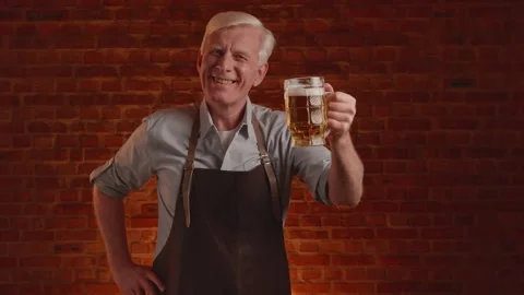 Gray-haired brewer posing with a glass of fresh craft beer Stock Footage 261853169