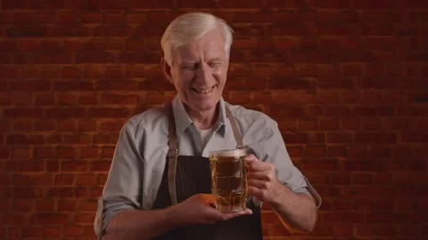 Gray-haired brewer posing with a glass of fresh craft beer Stock Footage 261853468