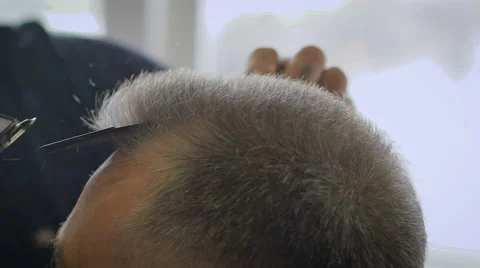 Gray-haired man in a barber shop. Hairstyle is almost ready, Barber leveled 스톡 동영상 63027296