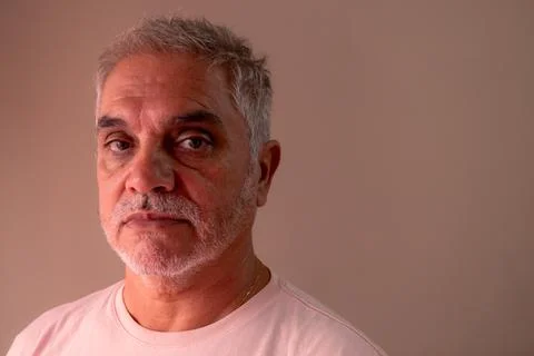 Gray-haired man between 50 and 60 years old with a serious look. An adult w.. Stock Photos