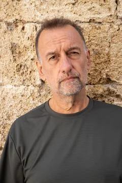 Gray-haired man between 50 and 60 years old with a serious look. An adult w.. Stock Photos