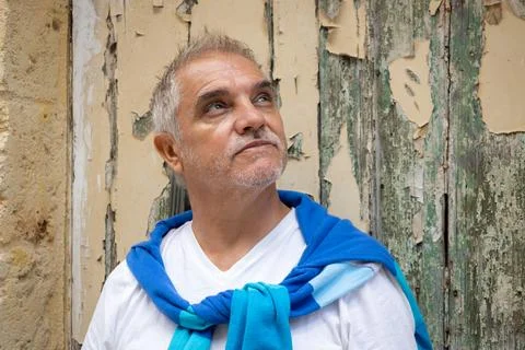 Gray-haired man between 50 and 60 years old, looking skyward. An adult with.. Stock Photos