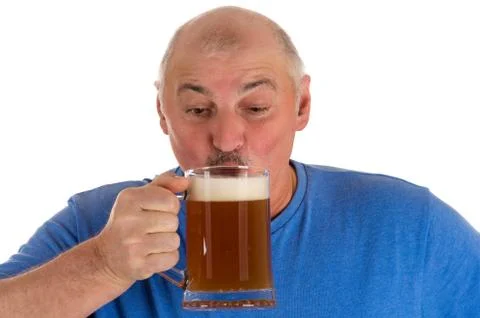Gray haired man drinking beer from a mug Stock Photos
