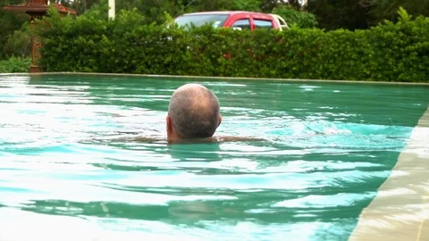 Gray-haired man in the pool Stock Footage 94040383