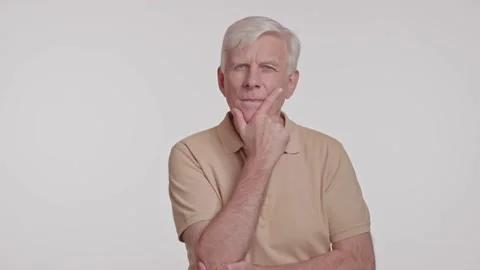 Gray haired man in a thoughtful pose, hand at chin studio shot Stock Footage 263931287